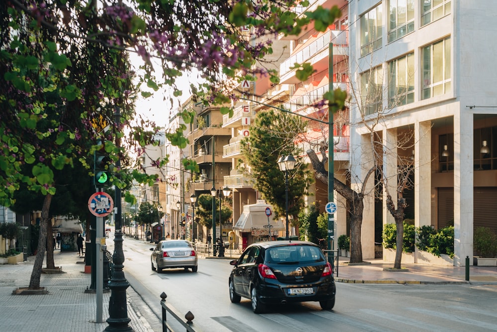 a car driving down a street next to tall buildings