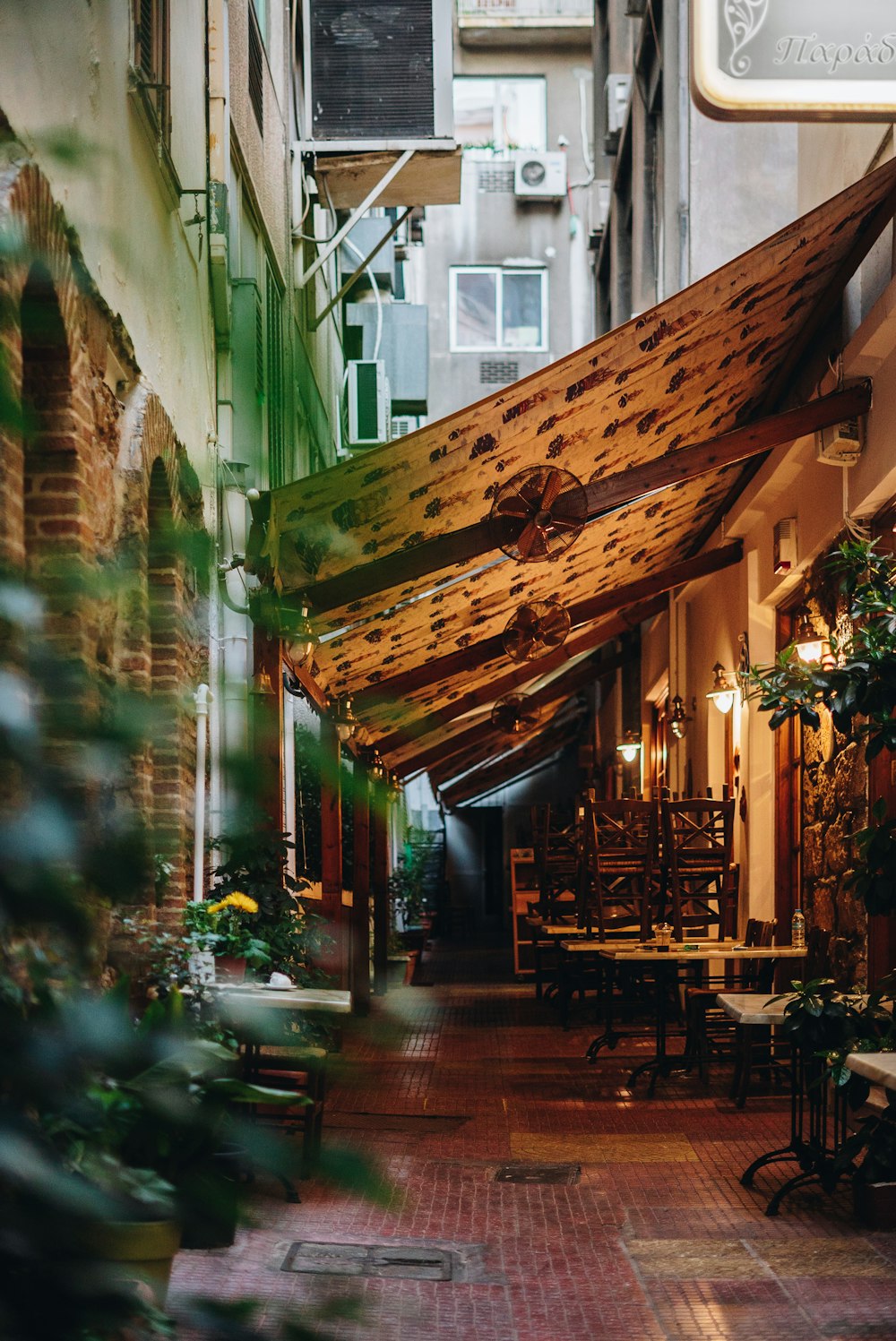 a restaurant with tables and chairs under a roof