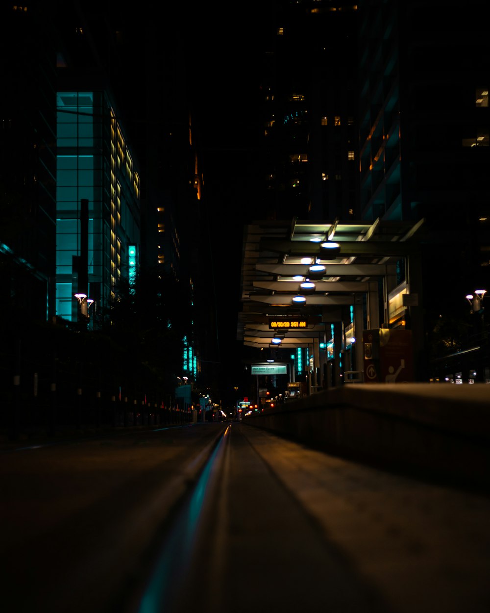 a city street at night with buildings lit up