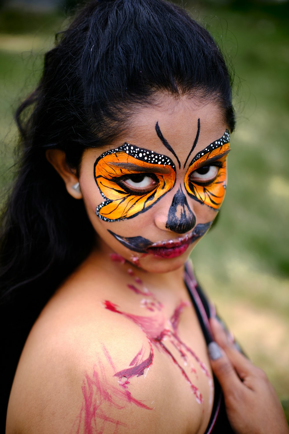 a woman with a butterfly painted on her face