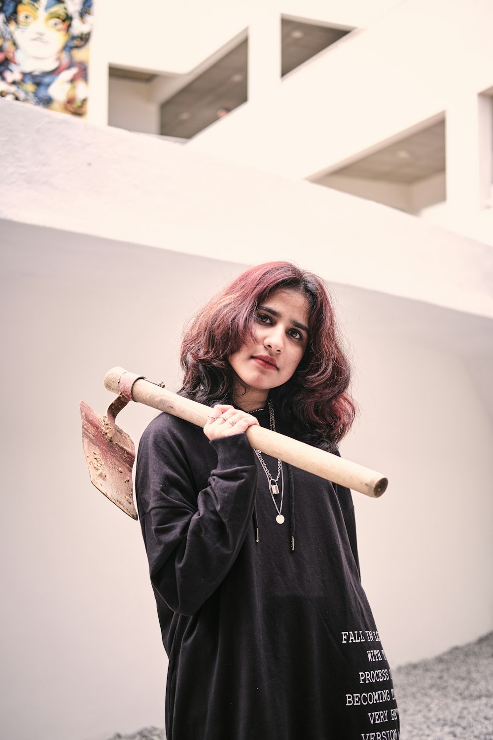 a woman holding a baseball bat in her hand