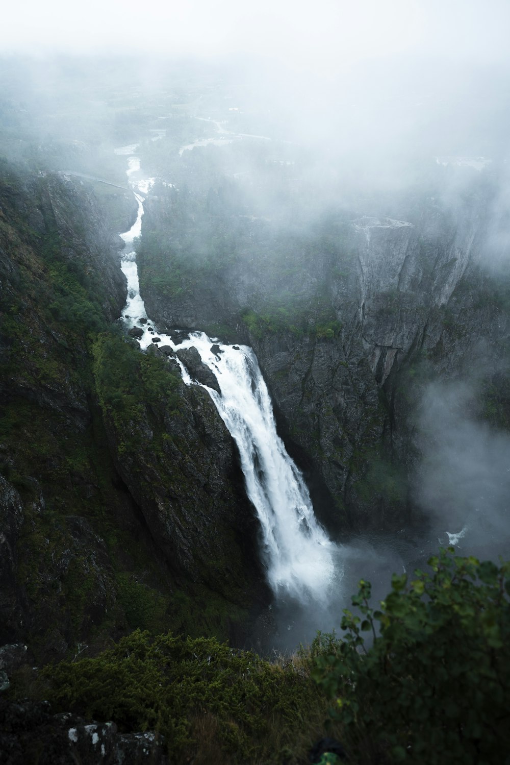 a large waterfall in the middle of a mountain