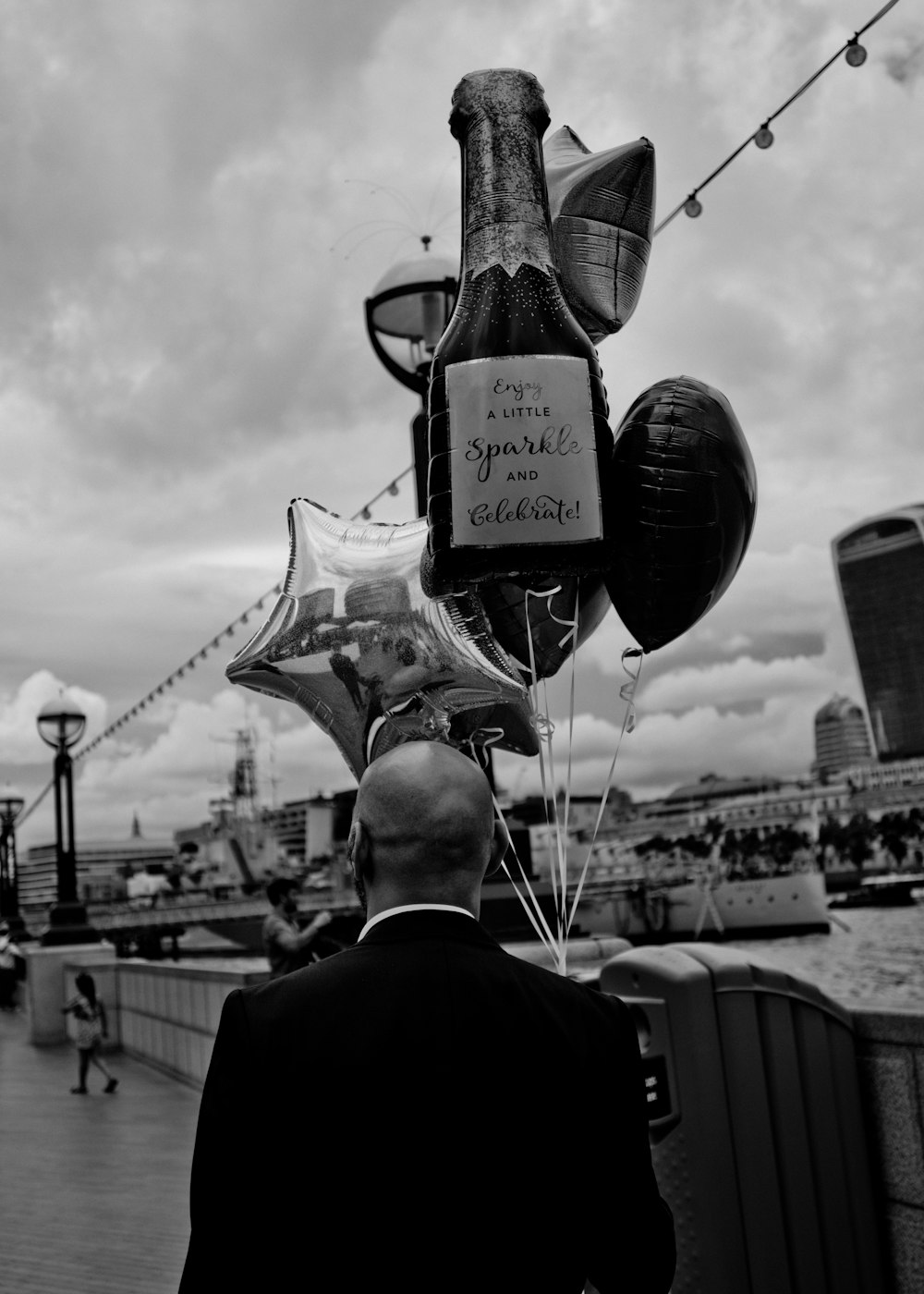 a man in a suit holding a star shaped balloon