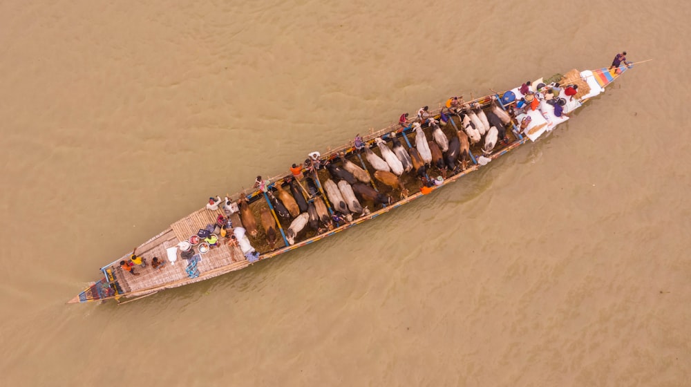 a long boat filled with people in the water