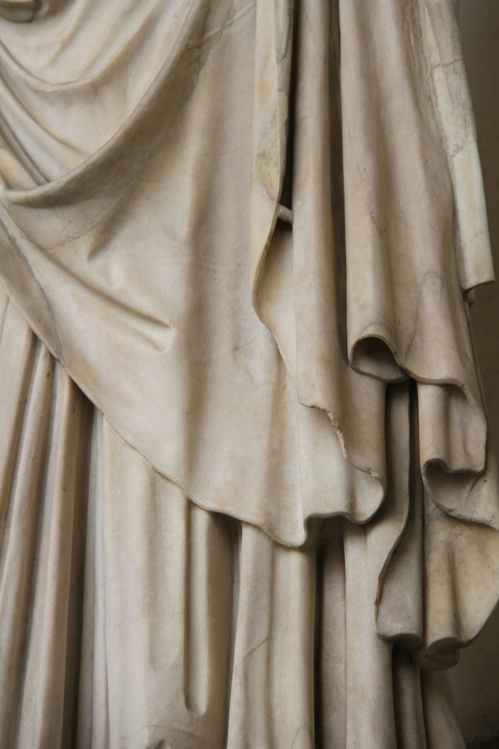 a close up of a statue with a curtain