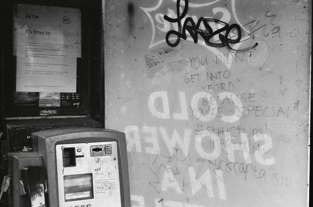 a black and white photo of a pay phone