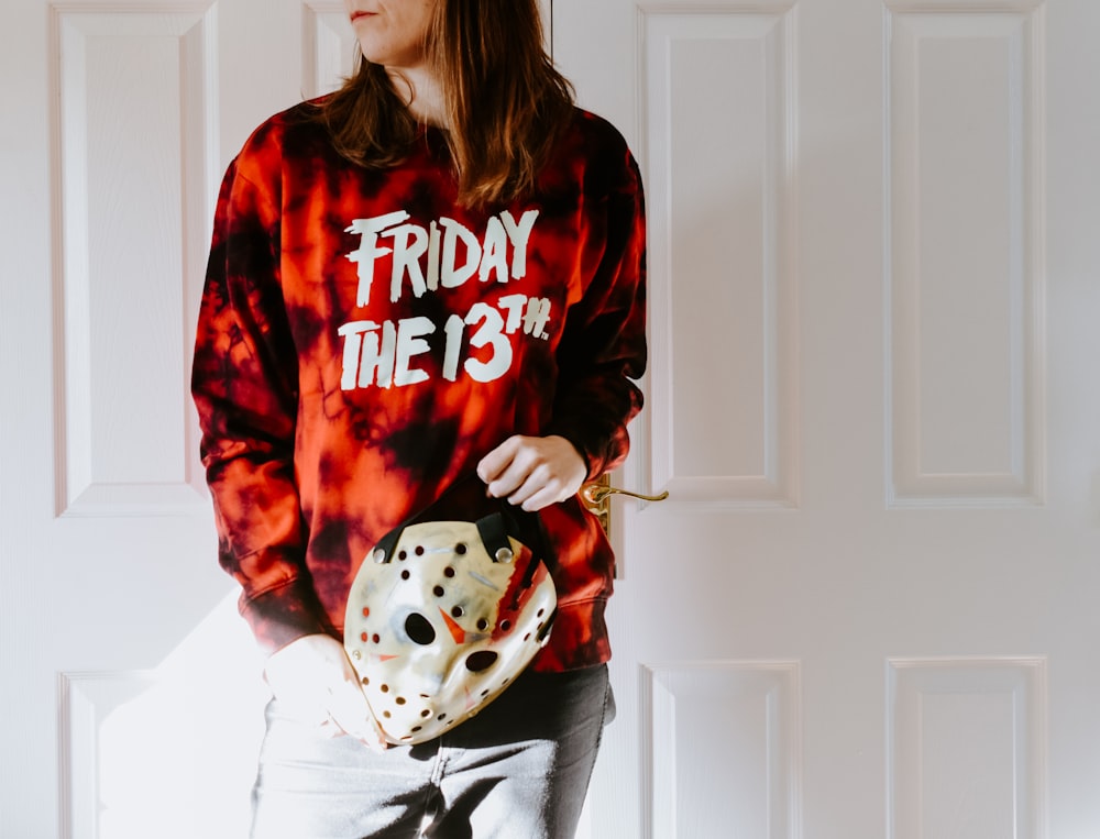 a woman in a tie dye shirt holding a dice bag