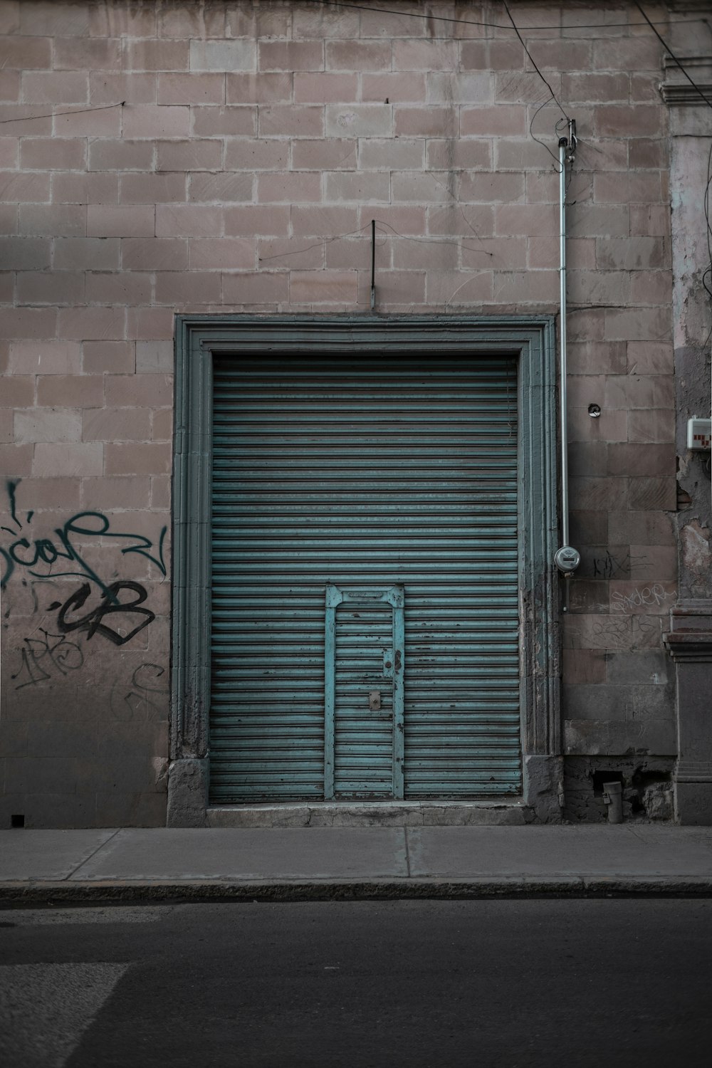 a garage door with graffiti on the side of a building