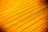 Golden-hued wooden planks arranged parallel to each other, with visible grain and texture.