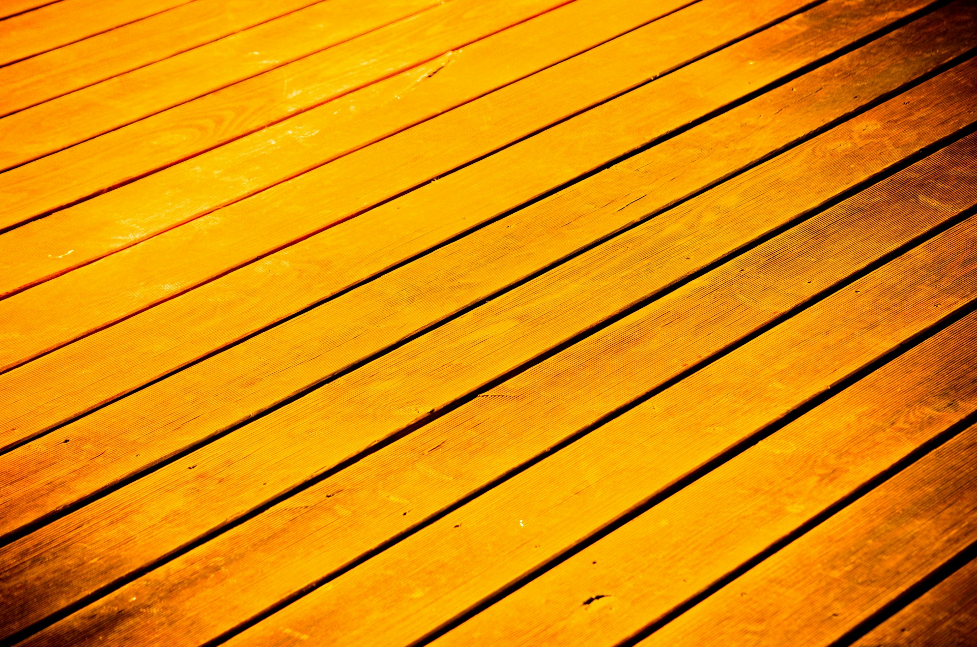 a close up of a wooden floor with a light shining on it