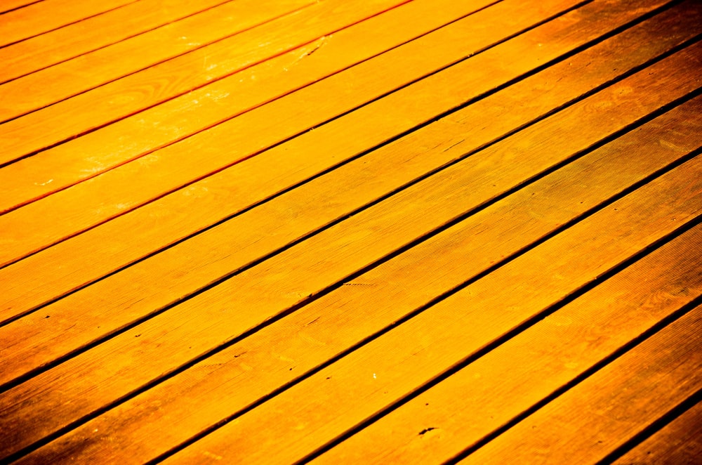 a close up of a wooden floor with a light shining on it