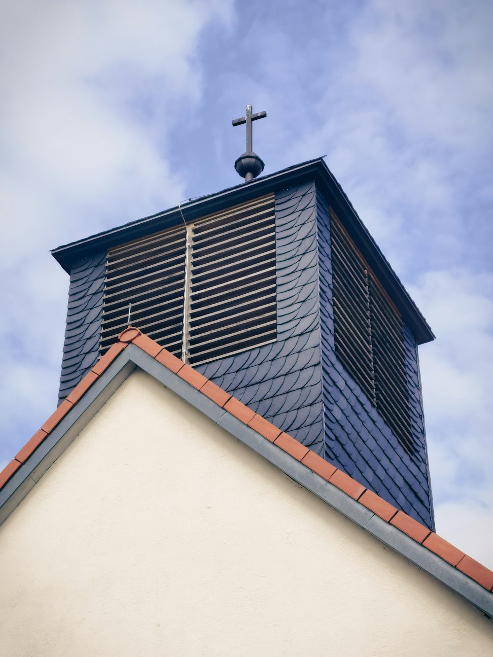 a church steeple with a cross on top