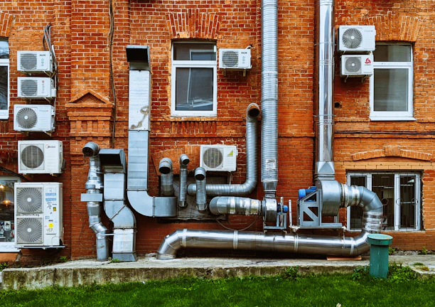 a building with a bunch of pipes on the side of it