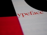 Text prominently featuring the word 'ypeface' written in red on a white background. The surrounding design includes blocks of contrasting colors, such as black and red, which create a bold and striking visual composition.