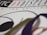 A close-up view of a graphic design featuring the text 'ON DISPLAY' highlighted in red on a white background. The letters are bold and part of a limited edition print design. Curved lines and shapes in black, green, and red are artistically arranged around the text.