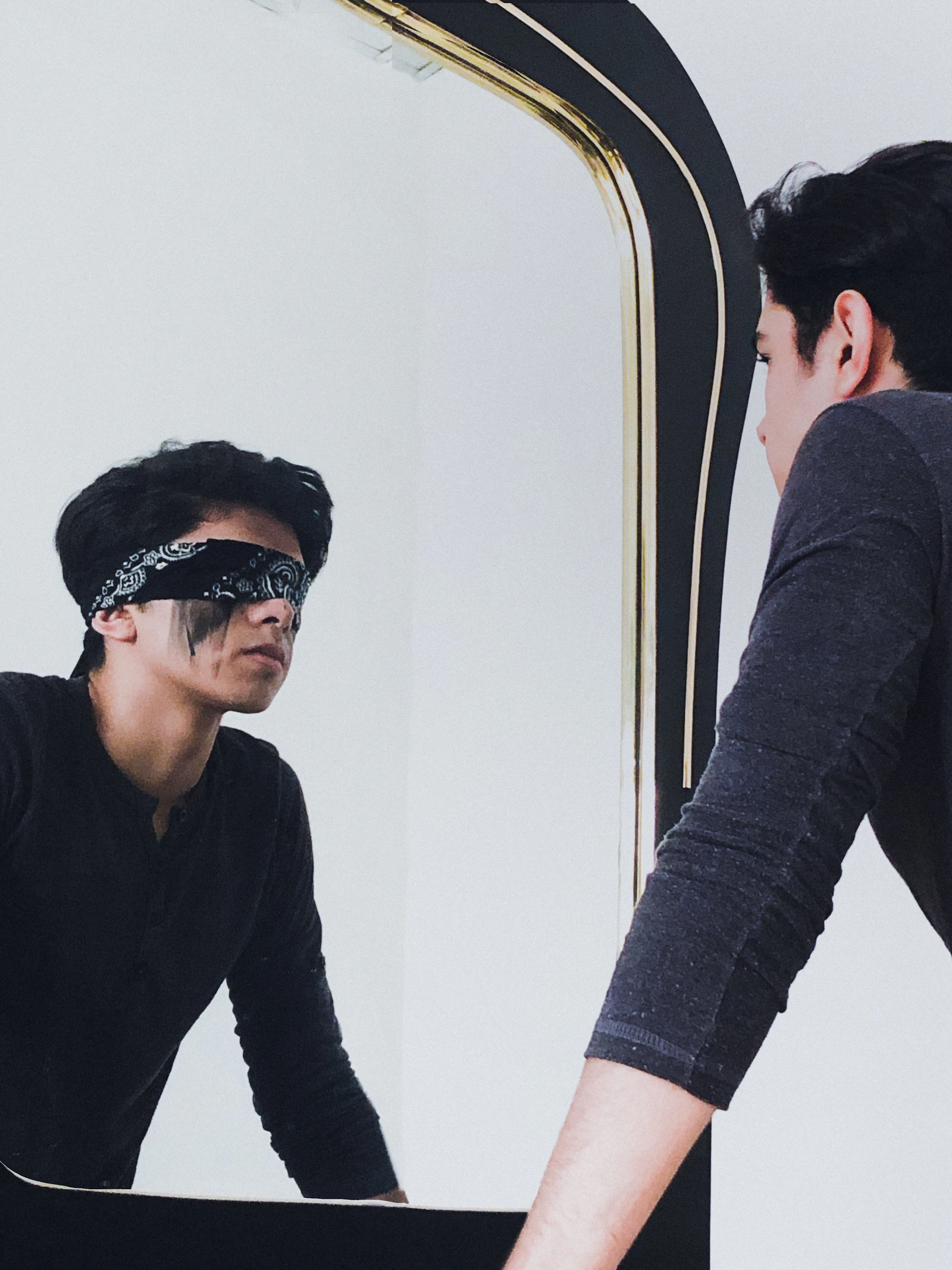 A man looking confidently at himself in a mirror