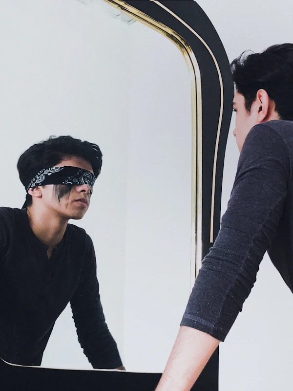 A man looking confidently at himself in a mirror