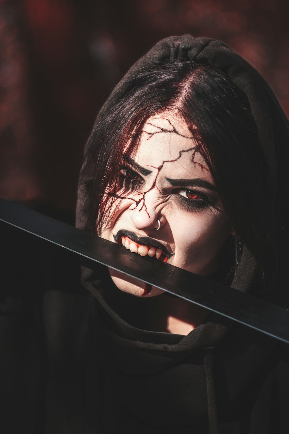 a woman with makeup and a knife in her hand