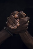 a close up of two people holding hands