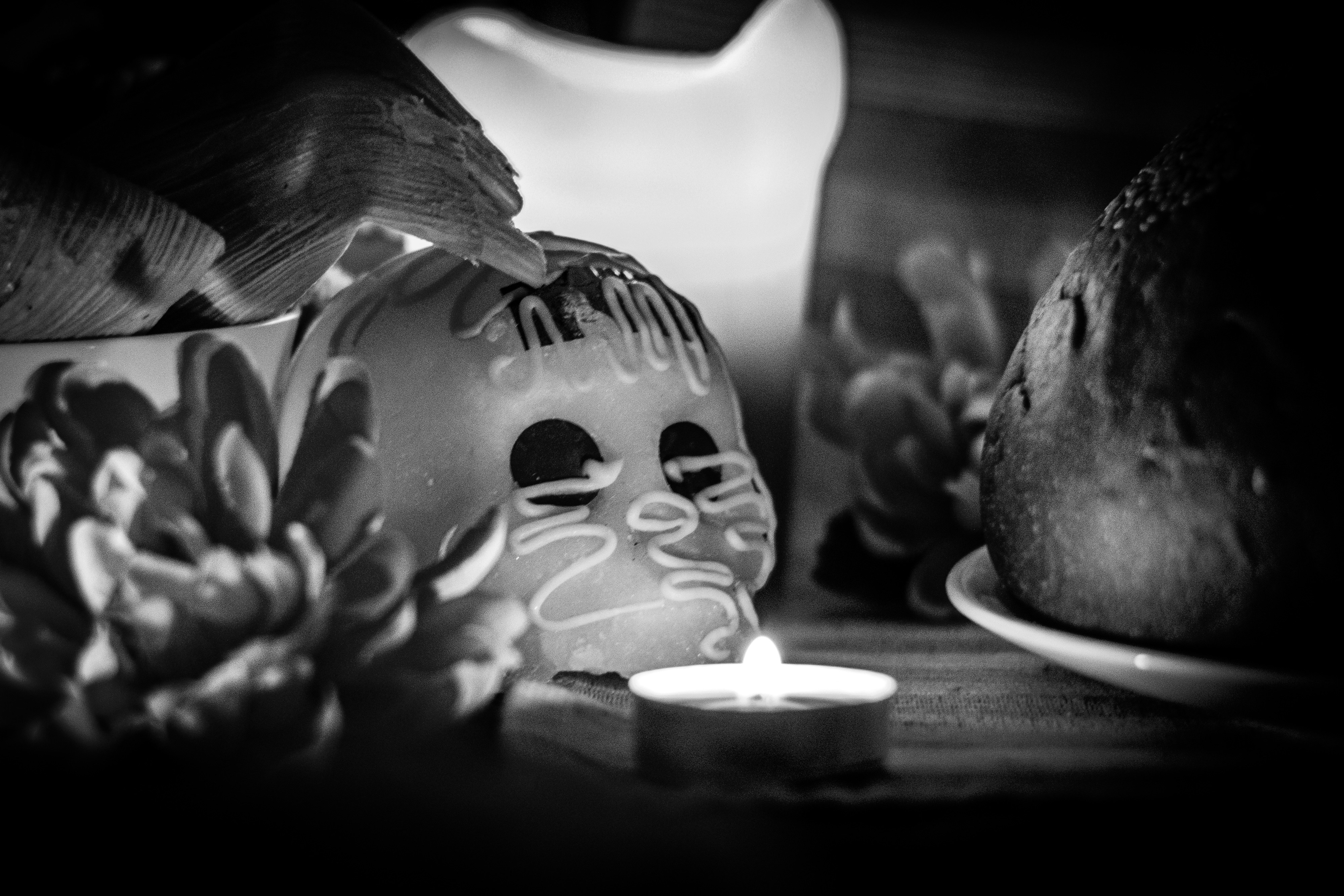a black and white photo of a candle and a skull, 