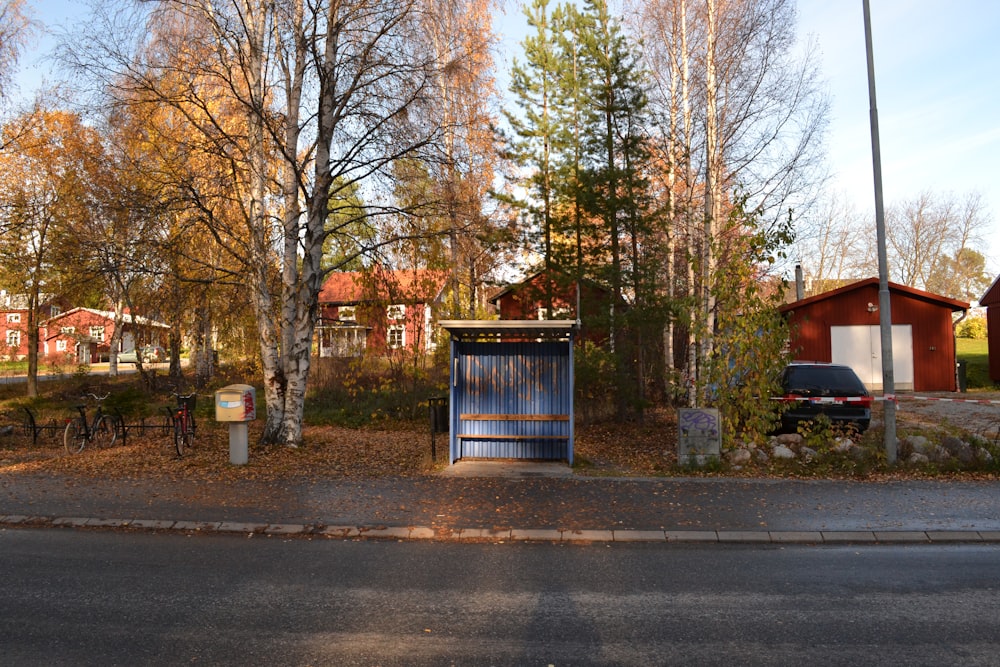 a small wooden building sitting on the side of a road