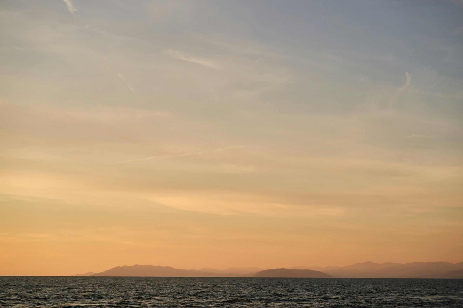 a boat is out on the water at sunset