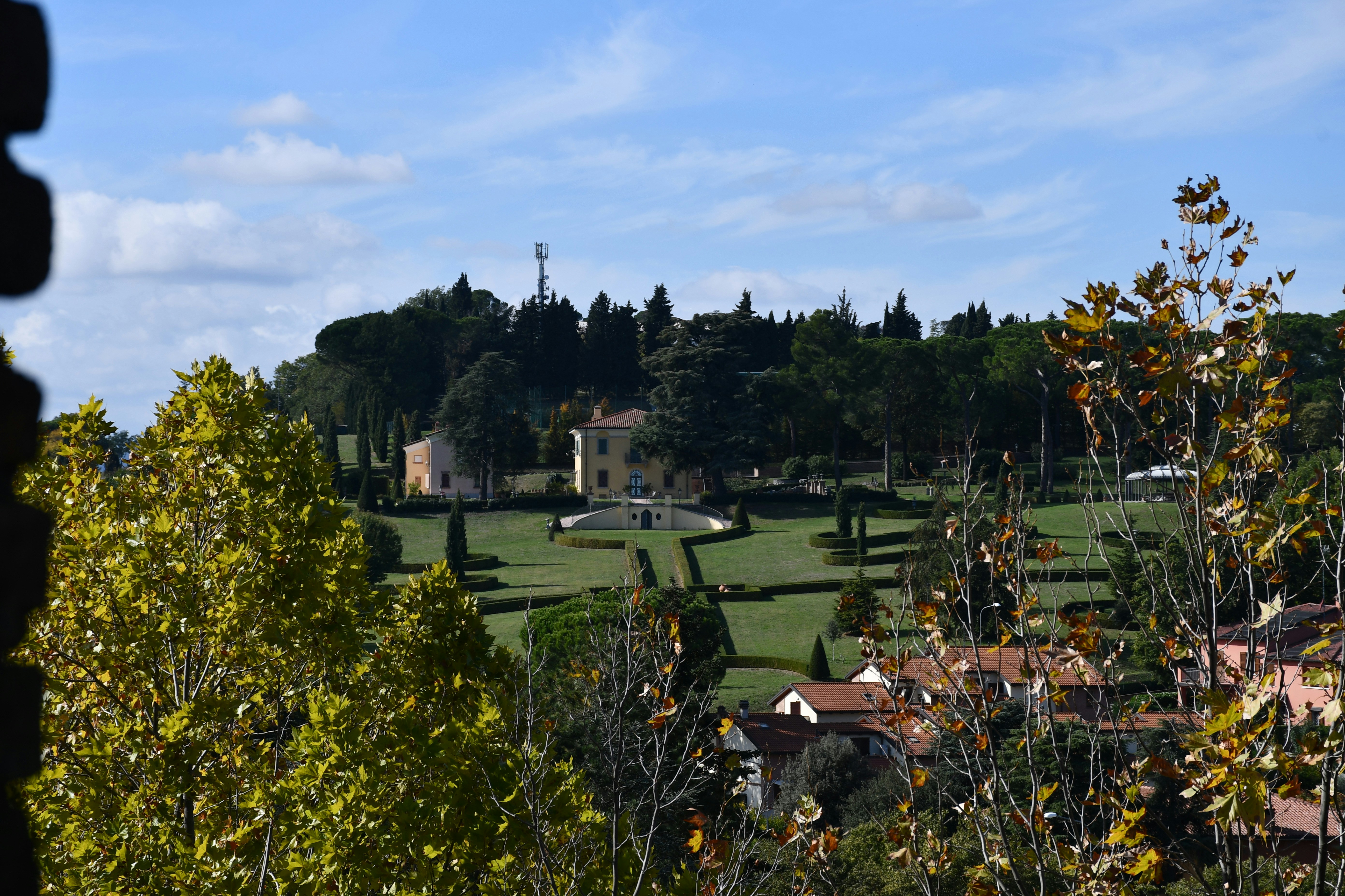 Premium villa site visit, warm golden afternoon light, manicured garden, bright open space, inviting atmosphere