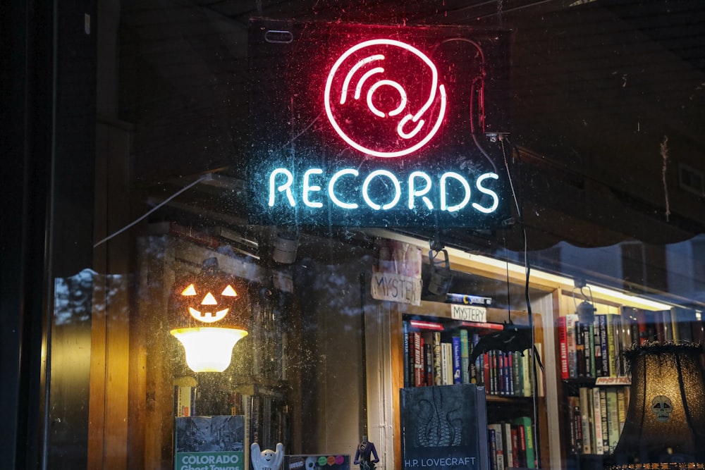 a record shop with a neon sign above it