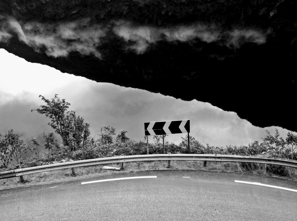 a black and white photo of a street sign