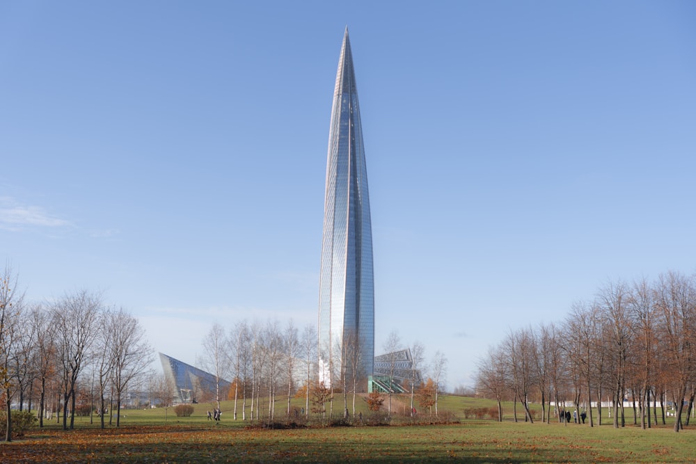 a very tall building in a big grassy field