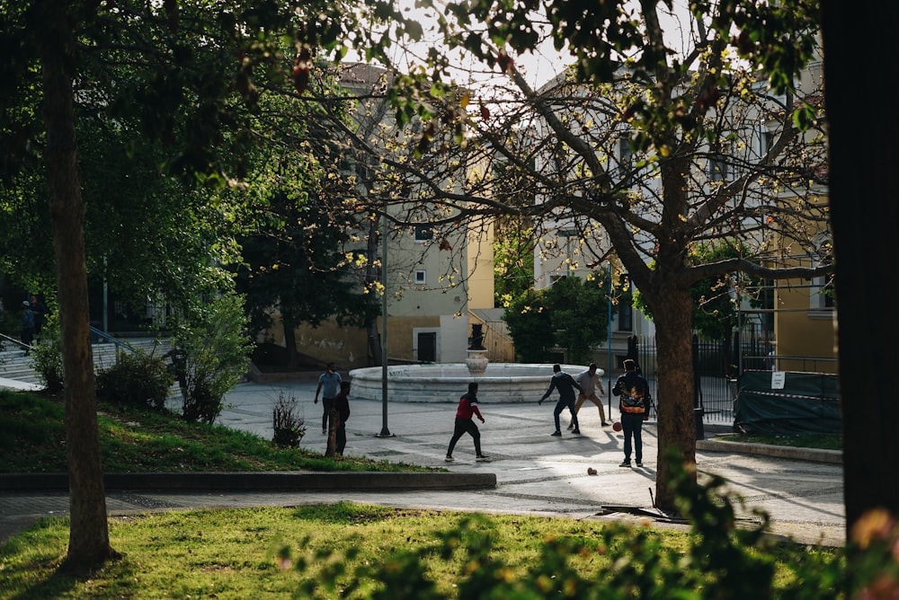 a group of people walking around a park