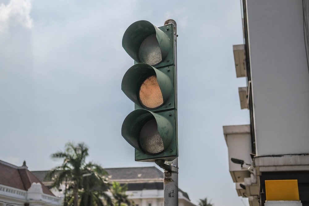 a traffic light on a pole in front of a building