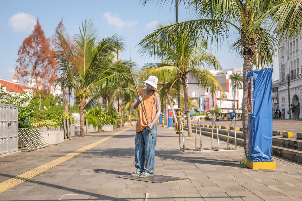 a man riding a skateboard down a street next to palm trees