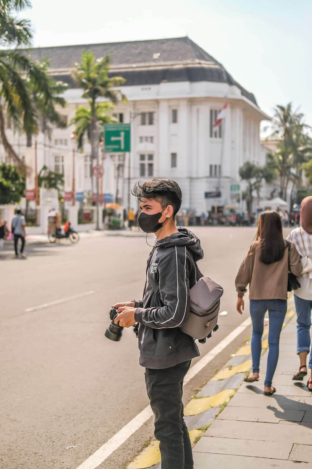 a man wearing a face mask while walking down the street