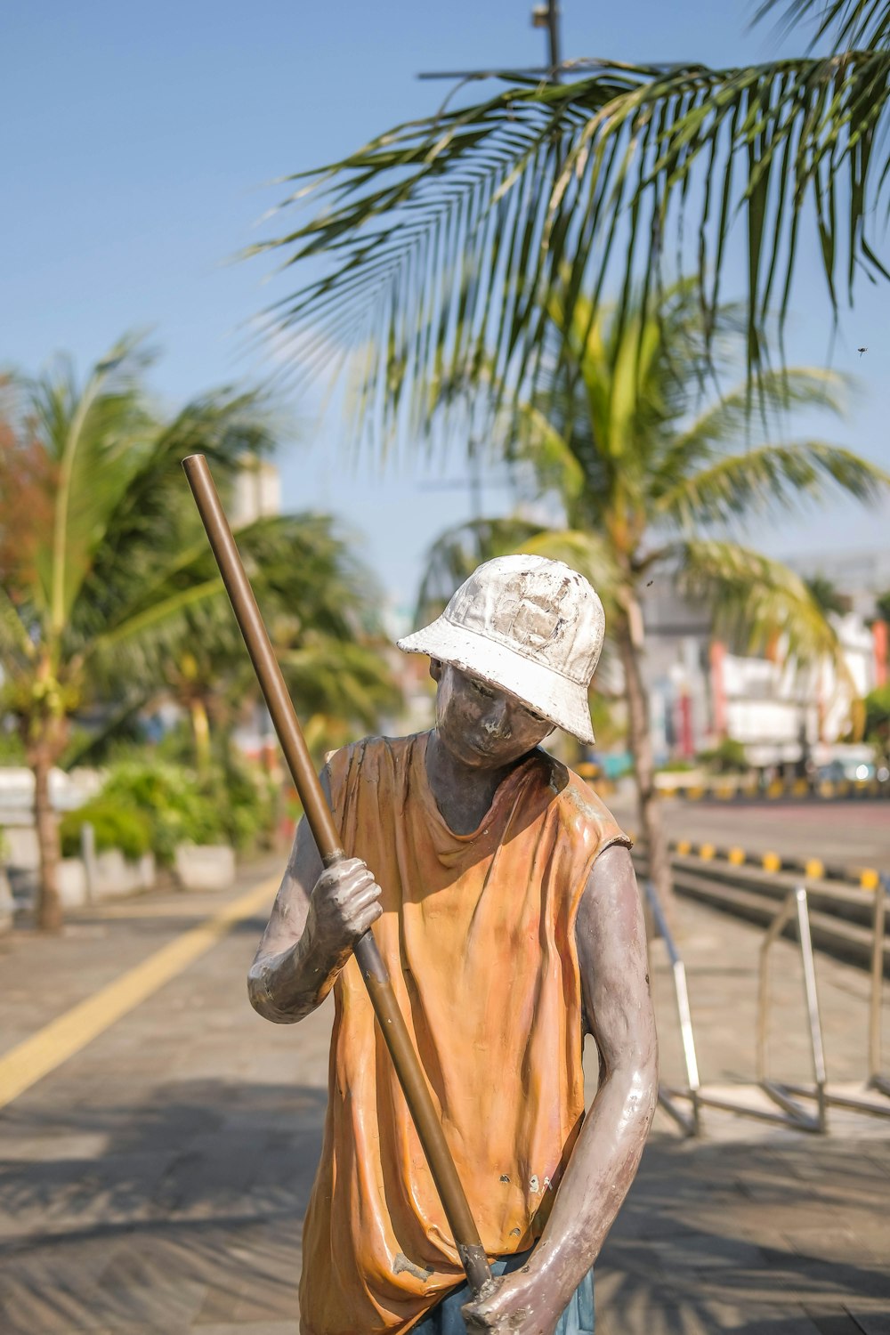 a statue of a man holding a stick