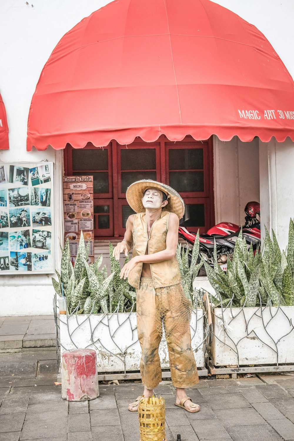 a statue of a man wearing a straw hat