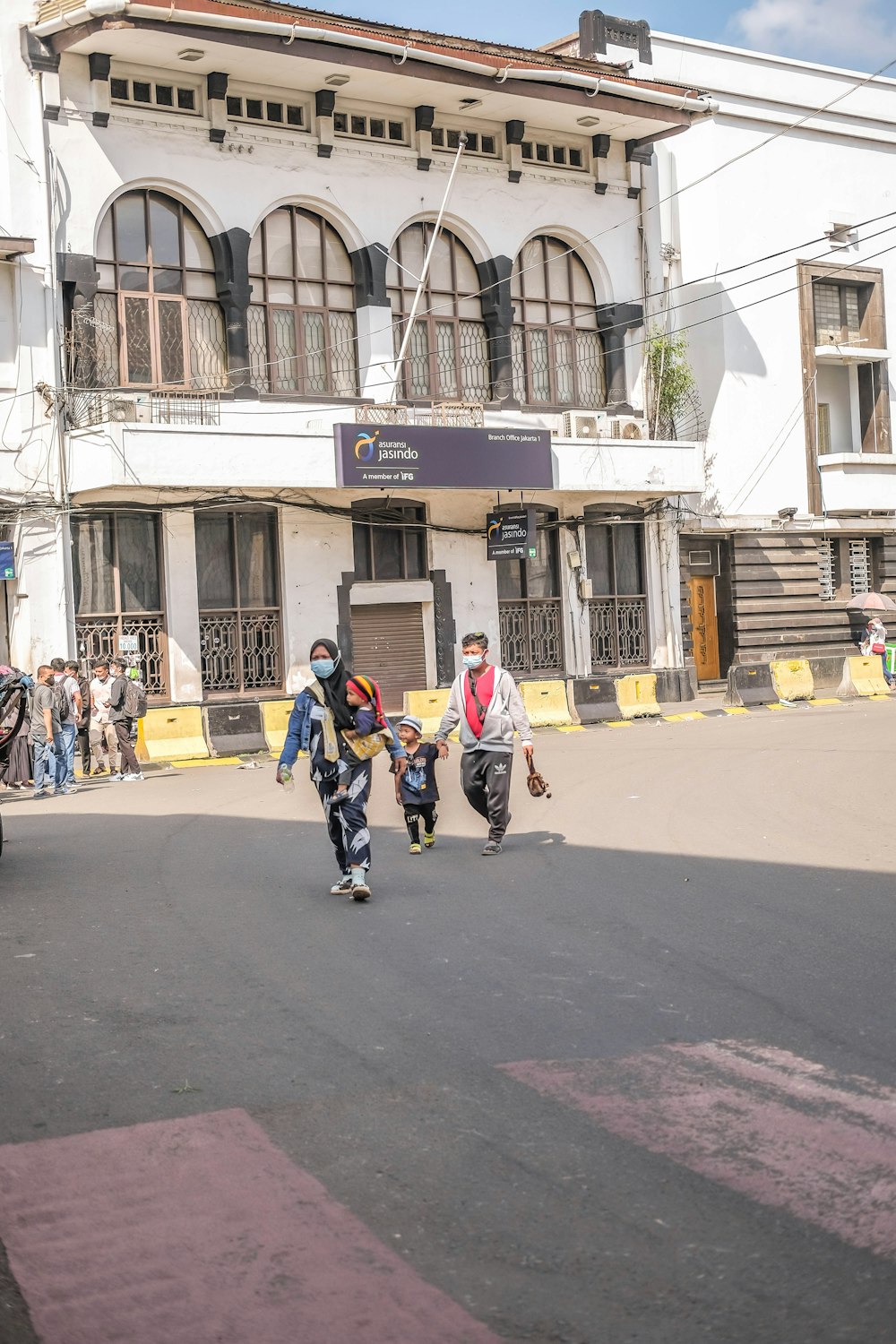 a group of people riding skateboards down a street