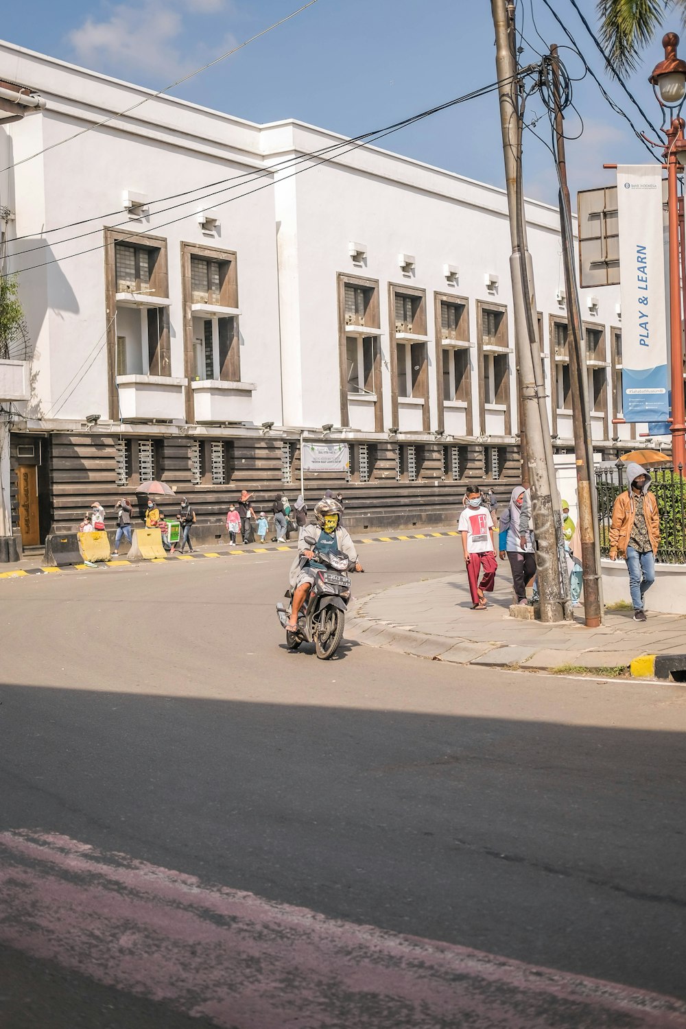 a group of people riding motorcycles down a street