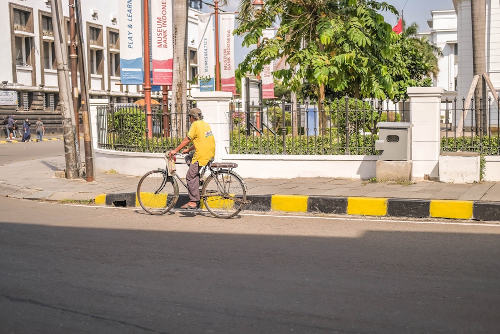a man riding a bike down a street