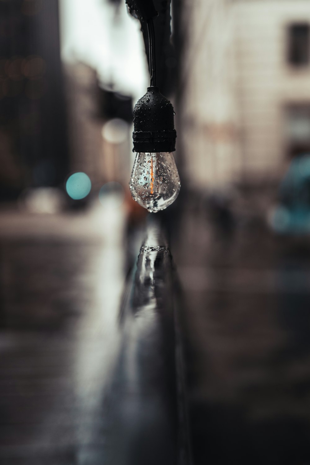 a light bulb hanging from the side of a building