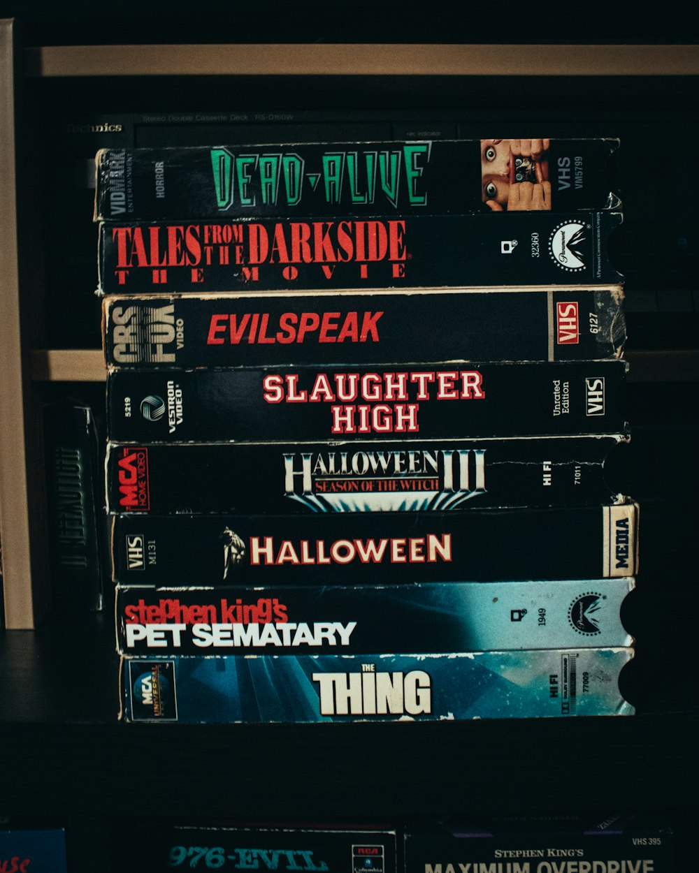 a stack of movies sitting on top of a shelf