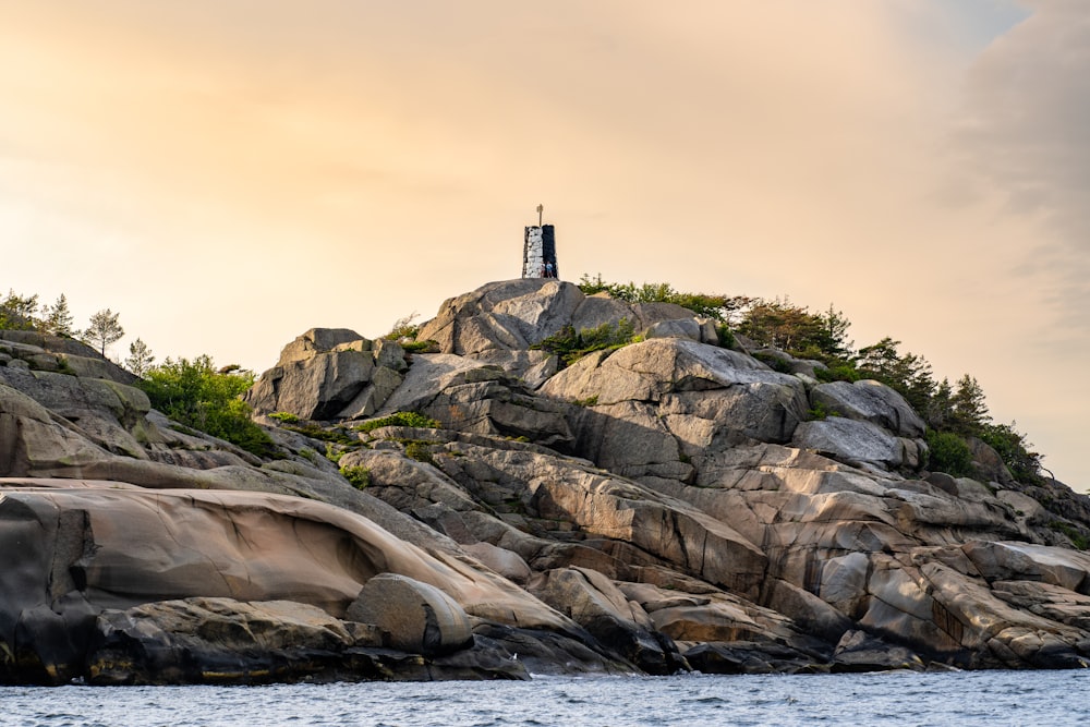 a lighthouse on top of a rocky outcropping