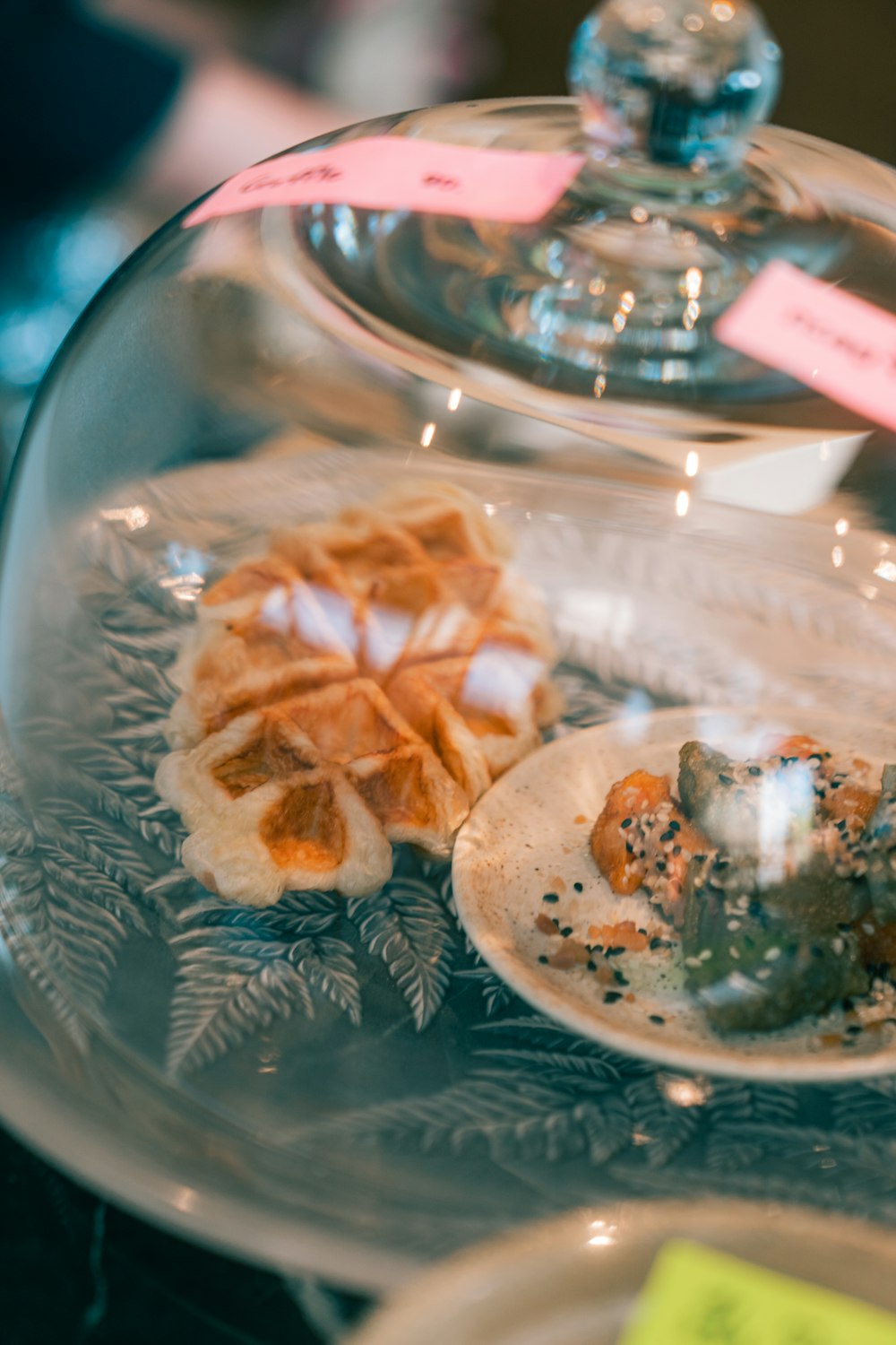 a glass plate topped with food on top of a table