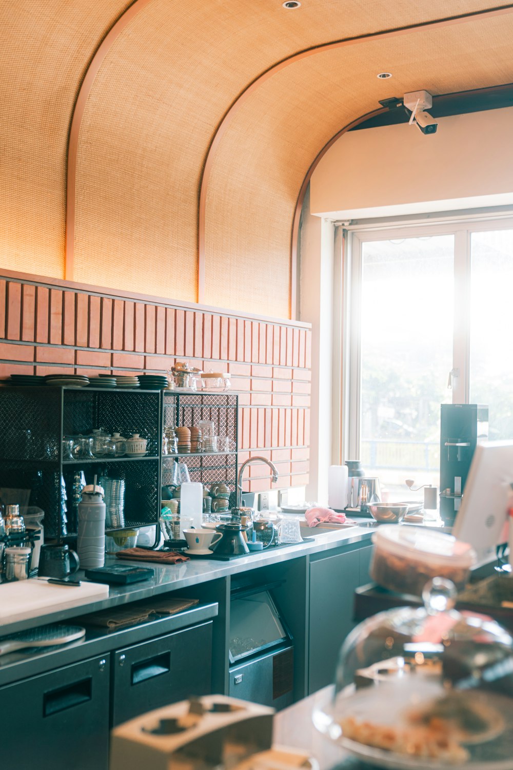 a kitchen with a lot of clutter on the counter