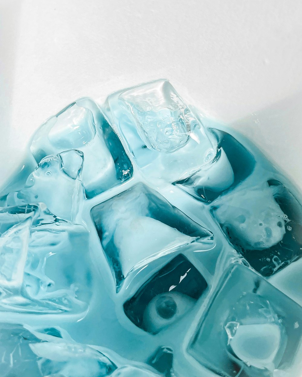 a close up of ice cubes on a white surface
