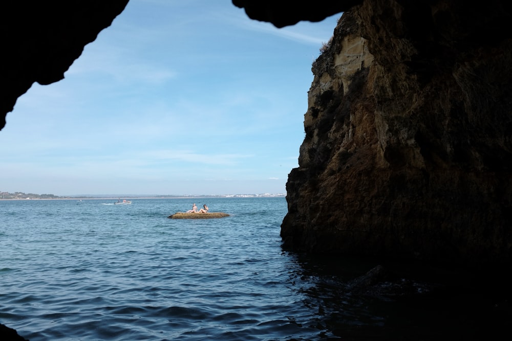 a couple of people in a small boat in the water