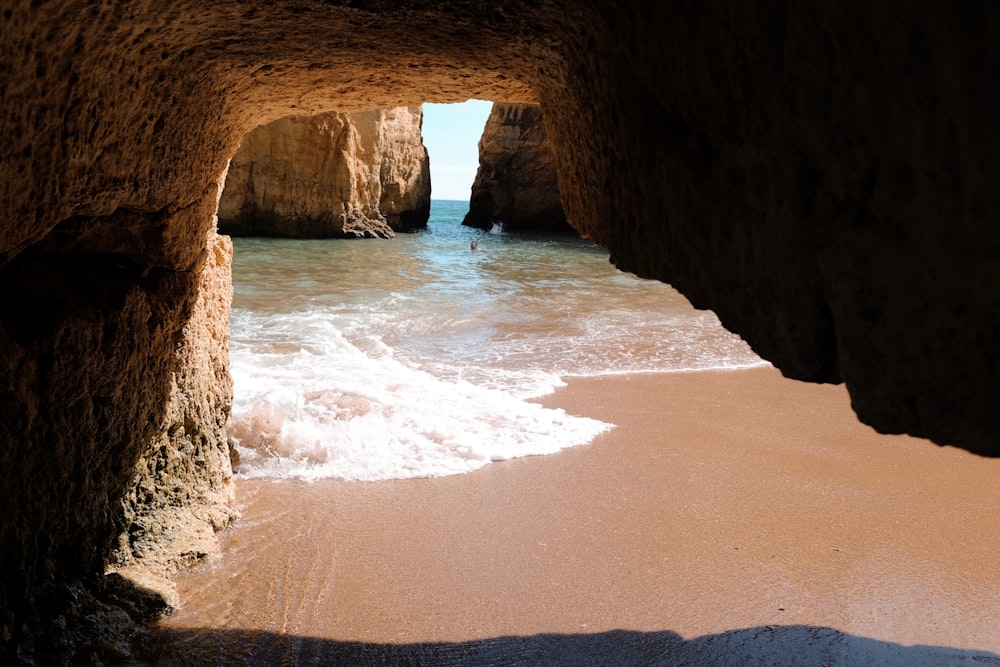 a view of the ocean from inside a cave