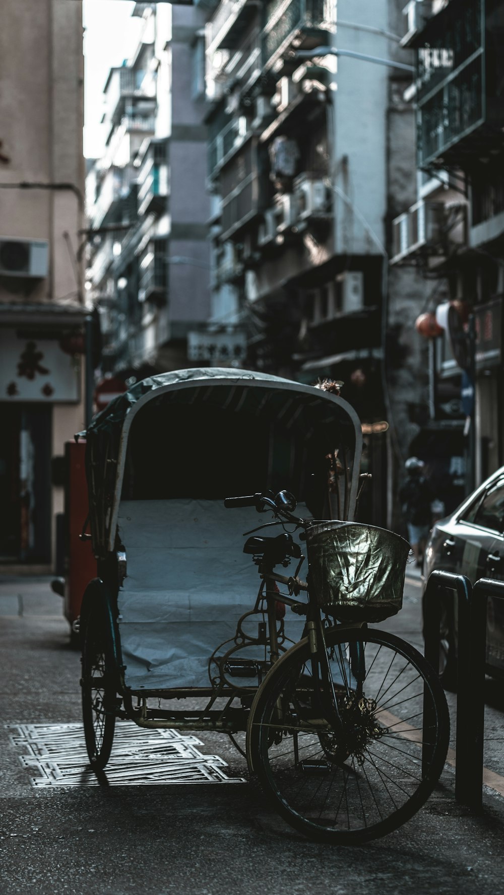 a bicycle is parked next to a car on a city street