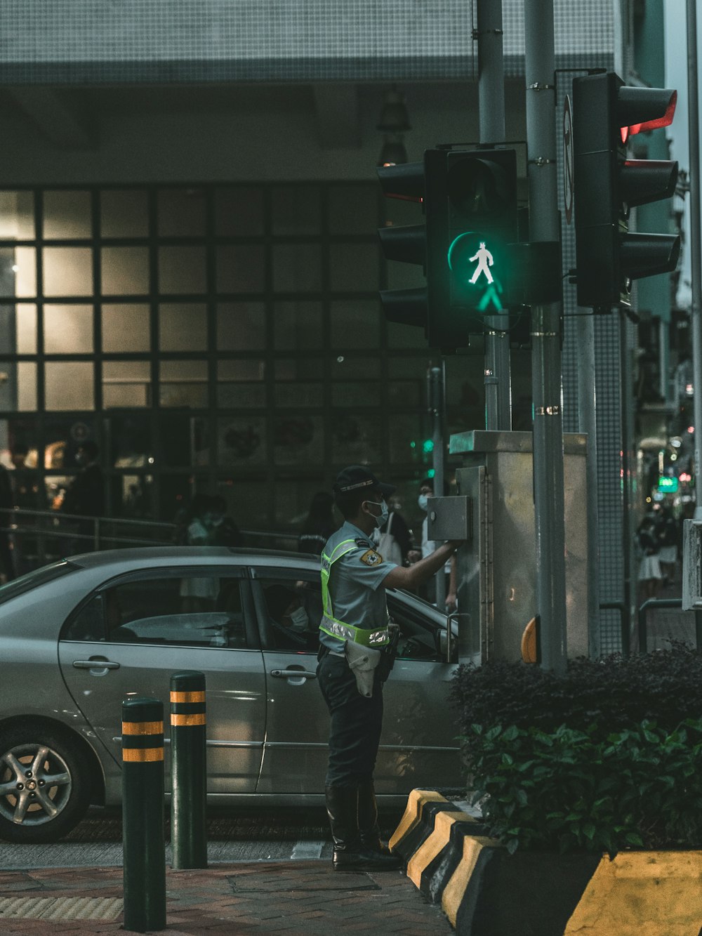 a man standing next to a green traffic light