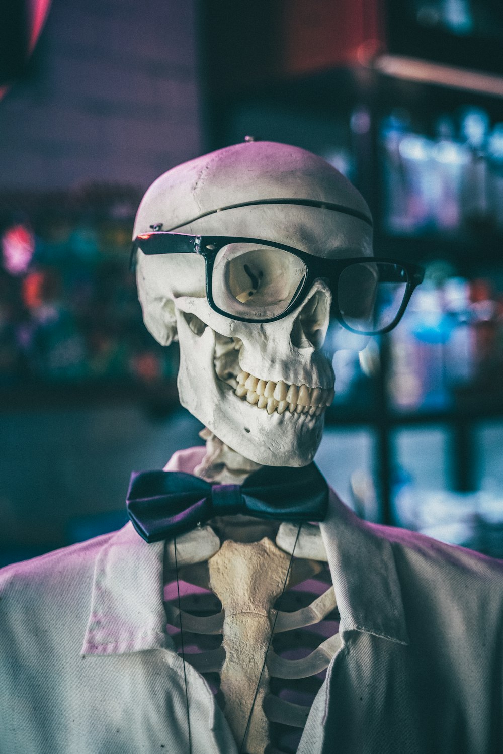 a skeleton wearing glasses and a bow tie